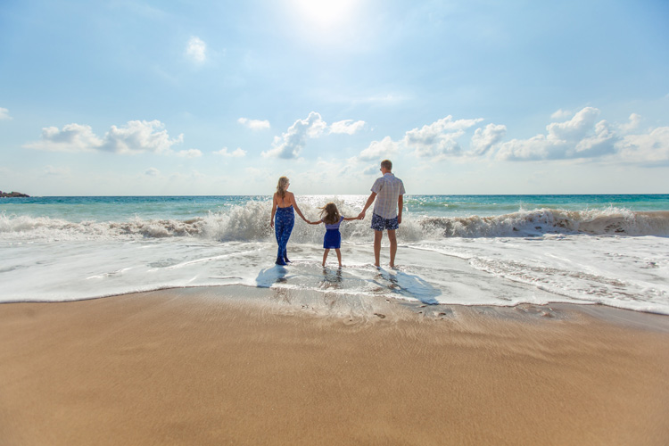 A family walking along a beach on a San Blas Island, Panama
